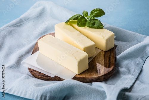 Принти на полотні Butter block on a chopping board . Fresh natural butter