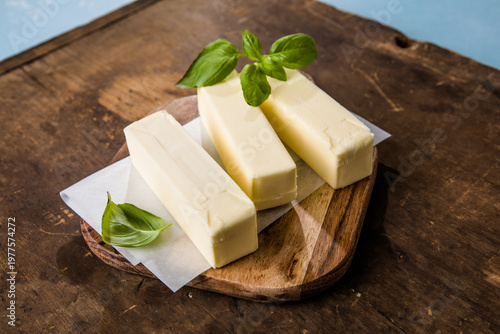 Tableau sur toile Butter block on a chopping board . Fresh natural butter