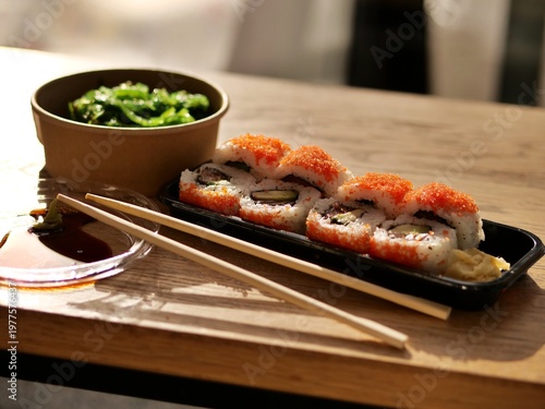 Canvas-taulu close-up shot of a fresh sushi take-out set on a wooden table