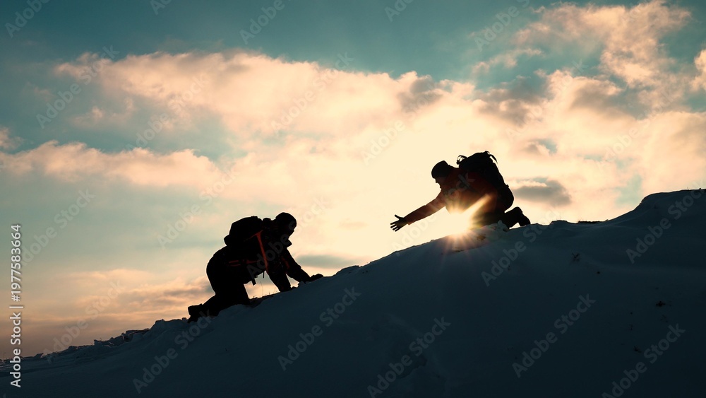 Fototapeta premium Teamwork business people. Go towards your goal. Travelers climb one after another on rock. Climbers silhouettes stretch their hands to each other climbing to top of hill. Team of businessmen victory