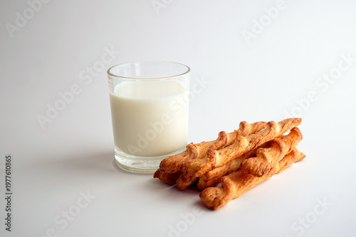 A glass of milk and puff pastry sticks, healthy nutrition.