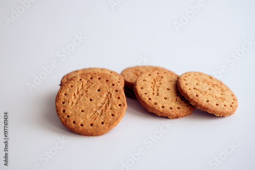 Stack of whole grain oatmeal cookies on light background.