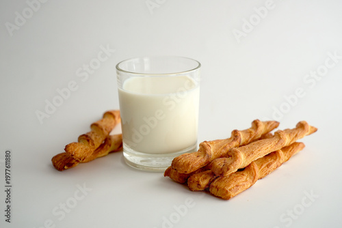 A glass of milk and puff pastry sticks, healthy nutrition.