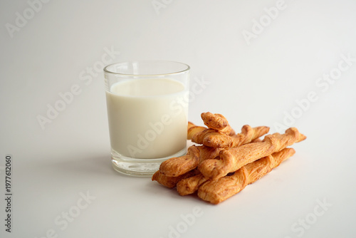 A glass of milk and puff pastry sticks, healthy nutrition.
