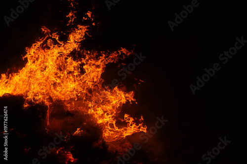intense fire consuming burning branches in the darkness