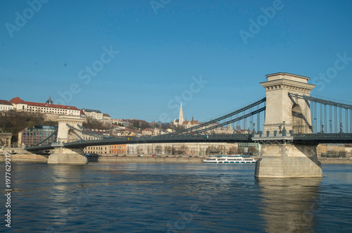 Szechenyi Chain Bridge over the Danube river with Matthias Church in the distance, Budapest, Hungary.