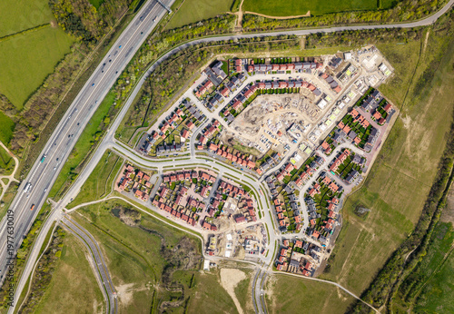 Aerial view directly above affordable new build housing construction site in the UK on green belt land