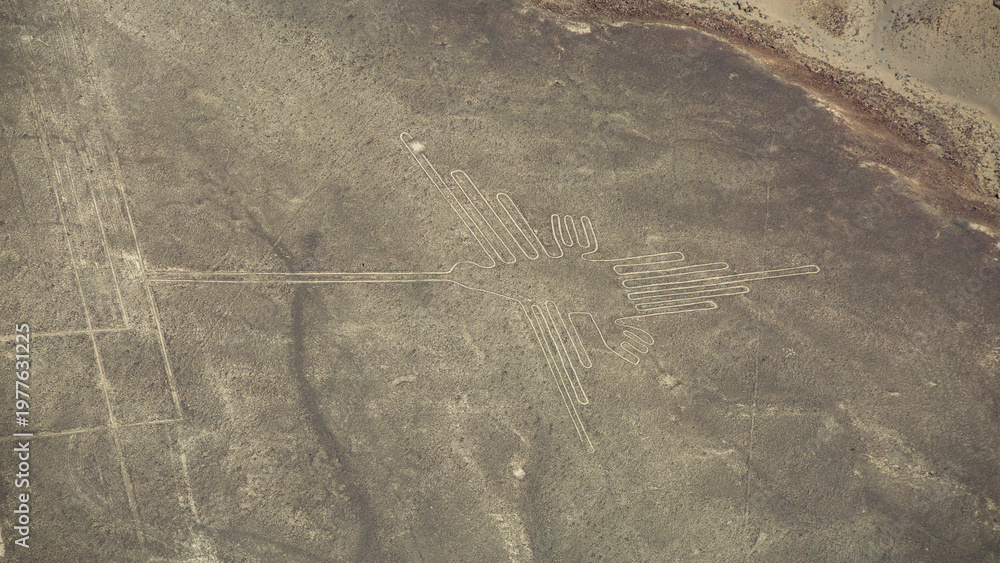 Fototapeta premium Aerial view of ancient Nazca Hummingbird geoglyph in Peru with copy space