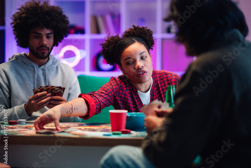 Cuadro en lienzo Diverse young friends playing board games and card games together during a relax
