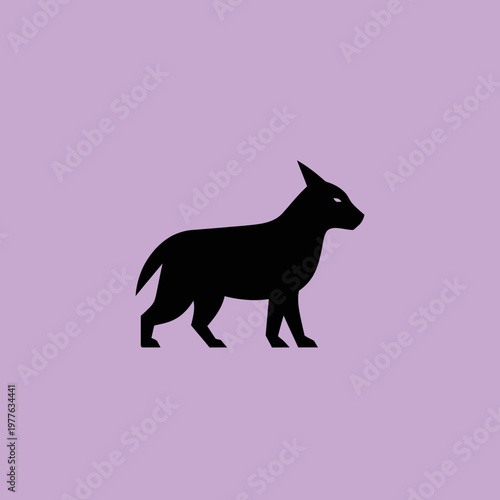 Silhouette of a black dog standing alert.