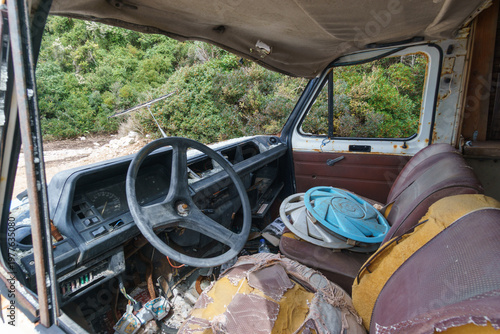 View inside an abandoned car wreck on a empty beach near Aquarium Beach, Himare, Albania
