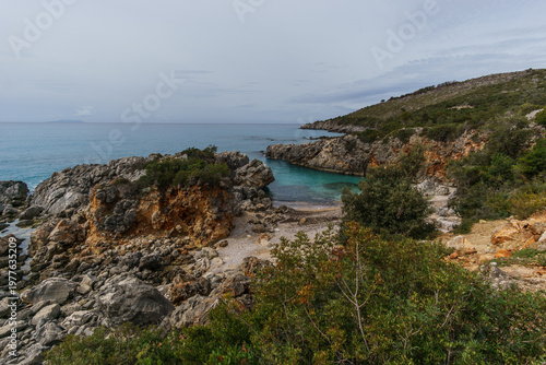 Aquarium bay with beach and rock formations on the Adriatic sea coast with turquoise colored water near Himare, Albania