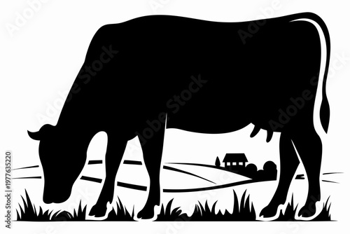 A black silhouette of a cow grazing in a rural landscape