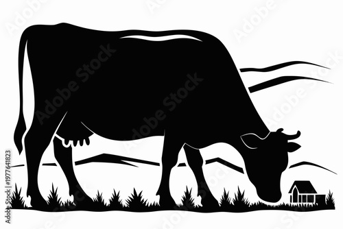 A black silhouette of a cow grazing in a rural landscape
