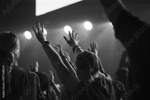 Bild auf Leinwand Black and white photo of crowd with raised hands at concert