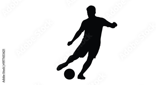 A dynamic soccer player in mid kick captured as a striking silhouette