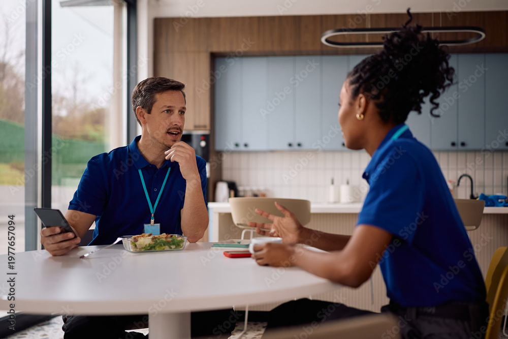 Fototapeta premium Commercial cleaning workers talking on lunch break at work.