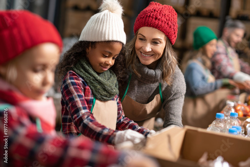 Group of diverse volunteers packing cardboard boxes with donated goods inside a bright warehouse, sorting items for delivery, natural busy atmosphere, charitable teamwork in action