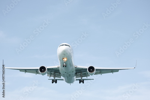 A huge passenger plane is landing in airport of Phuket, Thailand, a bottom view 