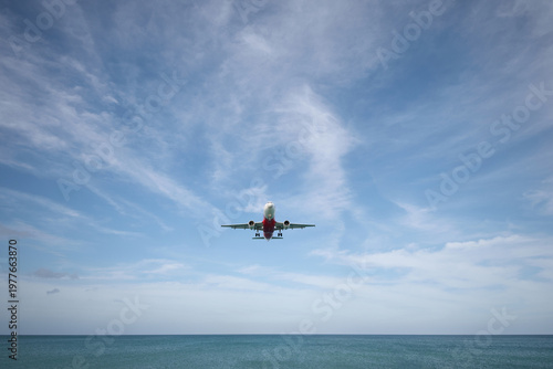 A huge passenger plane is landing in airport of Phuket, Thailand, a bottom view 