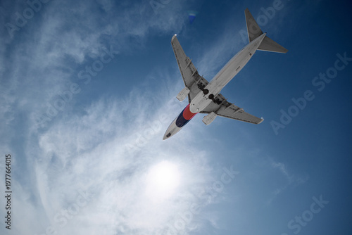 A huge passenger plane is landing in airport of Phuket, Thailand, a bottom view 