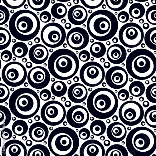 Small, varied black and blue circles isolated on a white background. Monochrome seamless pattern. Simple flat vector graphic illustration. Texture.
