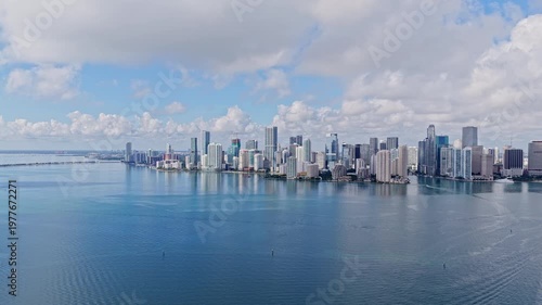 Miami Brickell skyline with blue sky and clouds. Miami aerial cityscape with skyline. Miami coastal skyline with ocean. Miami business towers skyline.