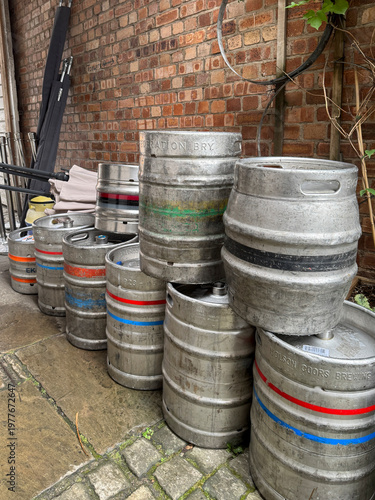 Leek Staffordshire December 20th 2024 Beer Kegs Lined Outside a Rainy Pub on a Cobblestone Alleyway