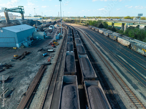 Принти на полотні Aerial view of large-scale industrial coal export terminal featuring loaded hopper cars on parallel rail tracks and heavy processing infrastructure