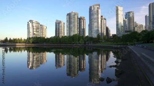 Quiet Sunrise Reflection False Creek Vancouver 4K UHD. Yaletown towers across the False Creek shoreline at sunrise in Vancouver. British Columbia, Canada. 4K, UHD.
