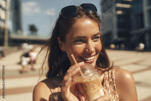 Warm smile and iced coffee delight on a sunny urban afternoon