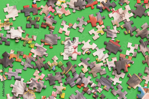 Puzzle pieces scattered on the floor as a background in natural light