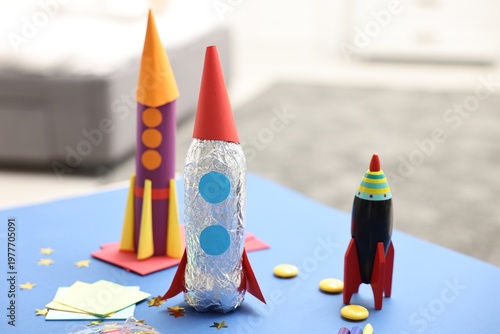 Bild auf Leinwand Toy and handmade rockets on blue table indoors, closeup