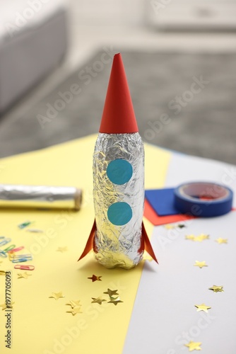 Handmade rocket and art materials on table indoors, closeup