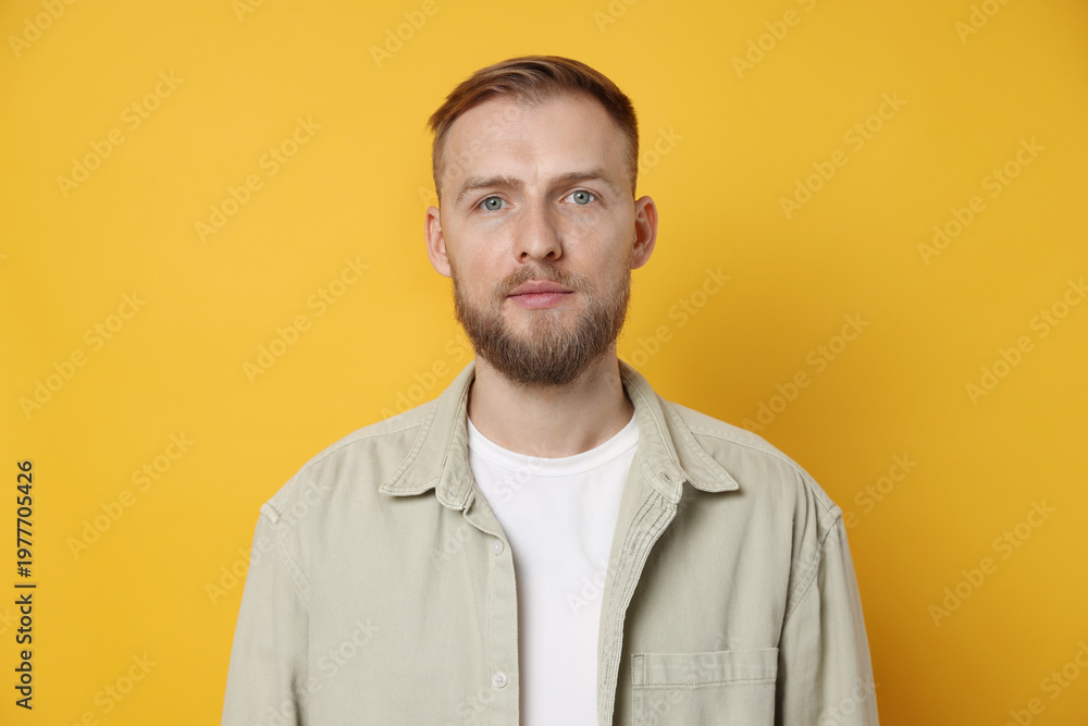 Fototapeta premium Portrait of handsome man on orange background