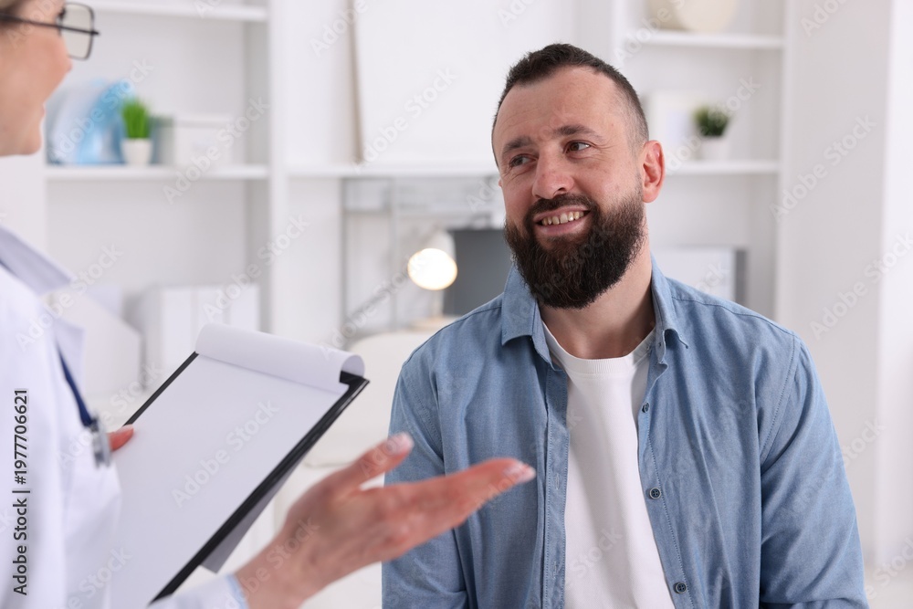 Fototapeta premium Man having appointment with doctor in clinic