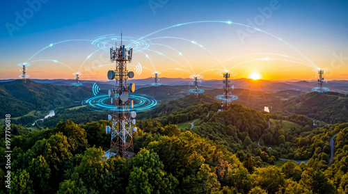 The scene shows cell towers in a rural setting at sunset. Signals from the towers connect various locations across the hills. The sky has warm colors and the landscape is green and lush
