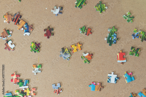 Puzzle pieces scattered on the floor as a background in natural light