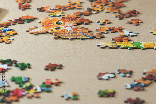 Puzzle pieces scattered on the floor as a background in natural light