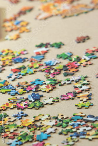 Puzzle pieces scattered on the floor as a background in natural light