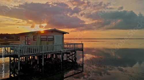 Drone flying low over the slake during sunset capturing gentle waves 