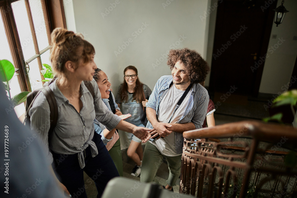 © Marko Geber - Smiling college students chatting on a university stairwell © Marko Geber - Smiling college students chatting on a university stairwell