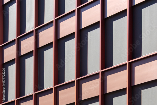 Modern Red Anodized Aluminum Building Facade with Unitized Glass Windows and Geometric Architectural Grid Pattern