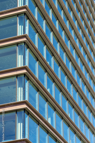 Contemporary Glass Skyscraper Facade with Horizontal Bronze Metal Fins and Geometric Window Patterns
