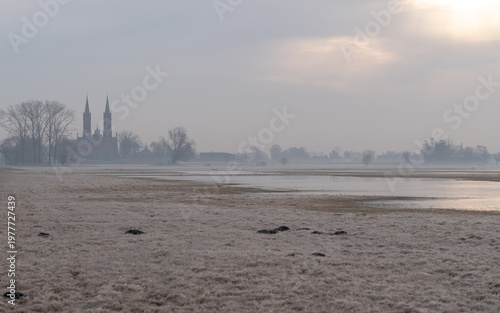 Flooded meadows with distant church in the Słudwia and Przysowa river valley, Poland
