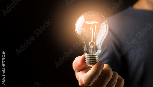 Wallpaper Mural A hand gently holds a glowing light bulb, illuminating the surrounding area with a warm light, symbolizing innovation and creativity Generative AI Torontodigital.ca