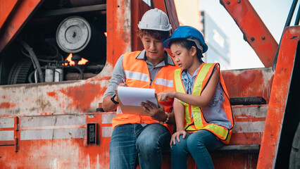 Construction worker hard hat safety vest father daughter clipboard excavation teamwork training engineer father with daughter father day reviewing clipboard construction site wearing hard hat