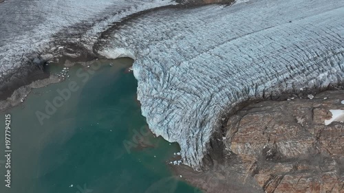 Drone shot of a massive glacier ending at the ocean near Kulusuk in East Greenland