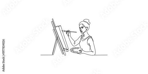 Woman painting on an easel with a paintbrush and palette in a studio