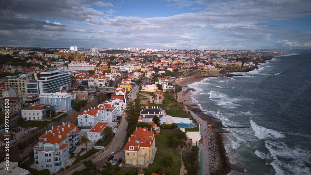 Fototapeta premium Aerial shot of Cascais coast with rolling waves and dramatic skyline